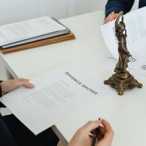 Two professionals discuss divorce decree documents, focusing on legal negotiations.